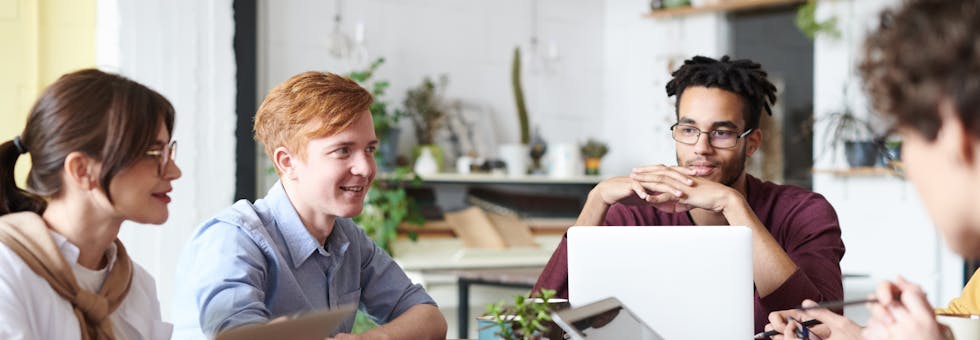 A team of engineers discussing on-call challenges and strategies in a tech company.